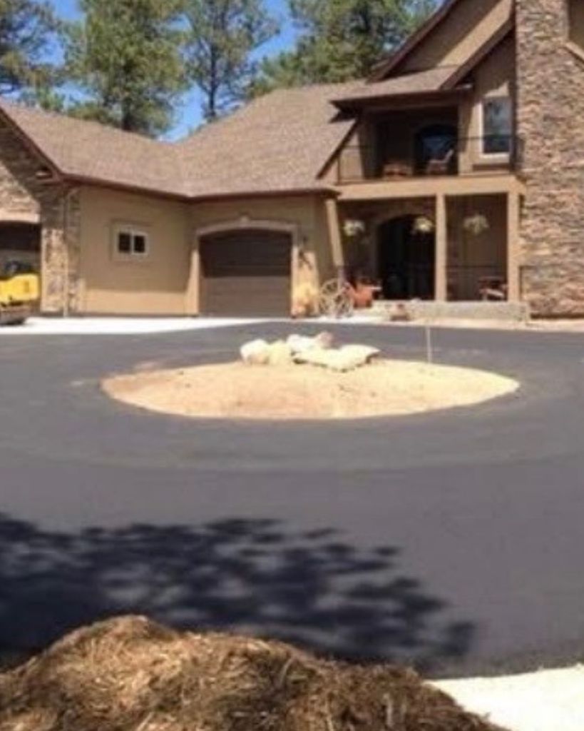 New 3.5 inch hot mix asphalt circular turnaround court and driveway installation at custom stone and stucco Black Forest home in Colorado Springs by Dawley Asphalt