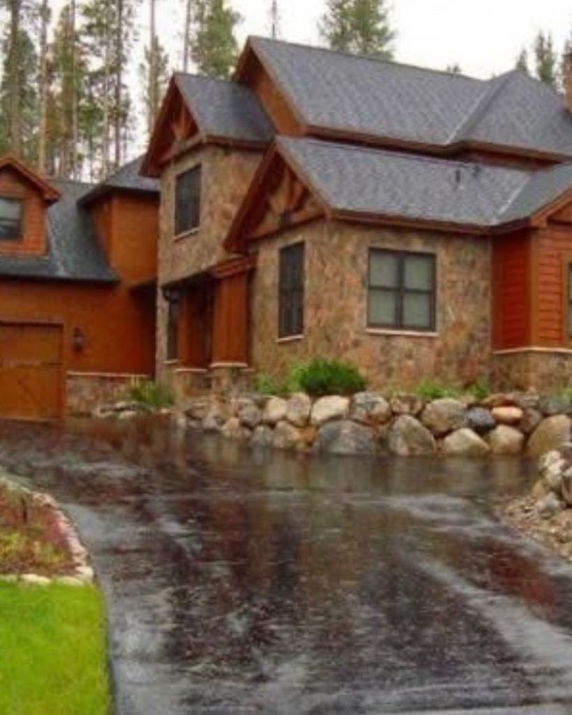 New 3.5 inch hot mix asphalt driveway installation at luxury stone and cedar mountain home with boulder retaining wall in Breckenridge Colorado by Dawley Asphalt